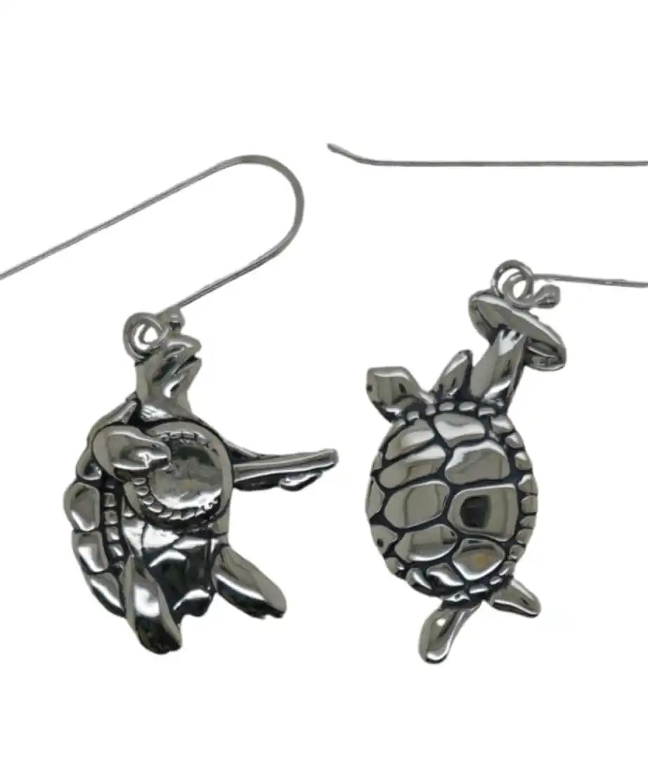 A pair of sterling silver earrings designed in the shape of terrapin turtles, one turtle playing a banjo and the other playing a tambourine, suspended from hooks.