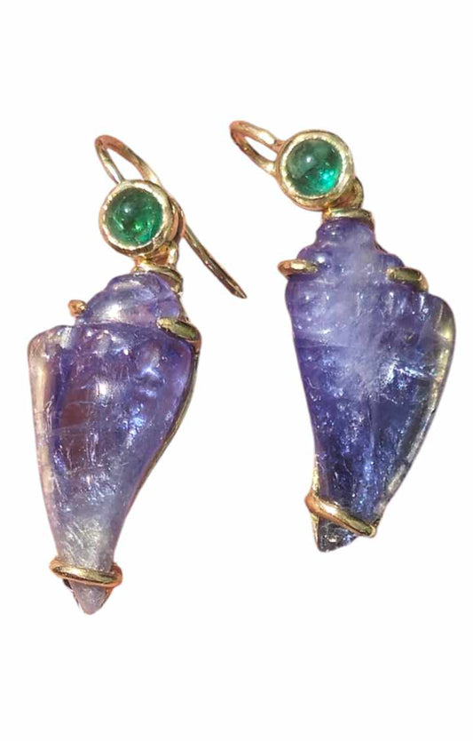 Purple shell-shaped earrings with gold accents and green gemstones on a white background