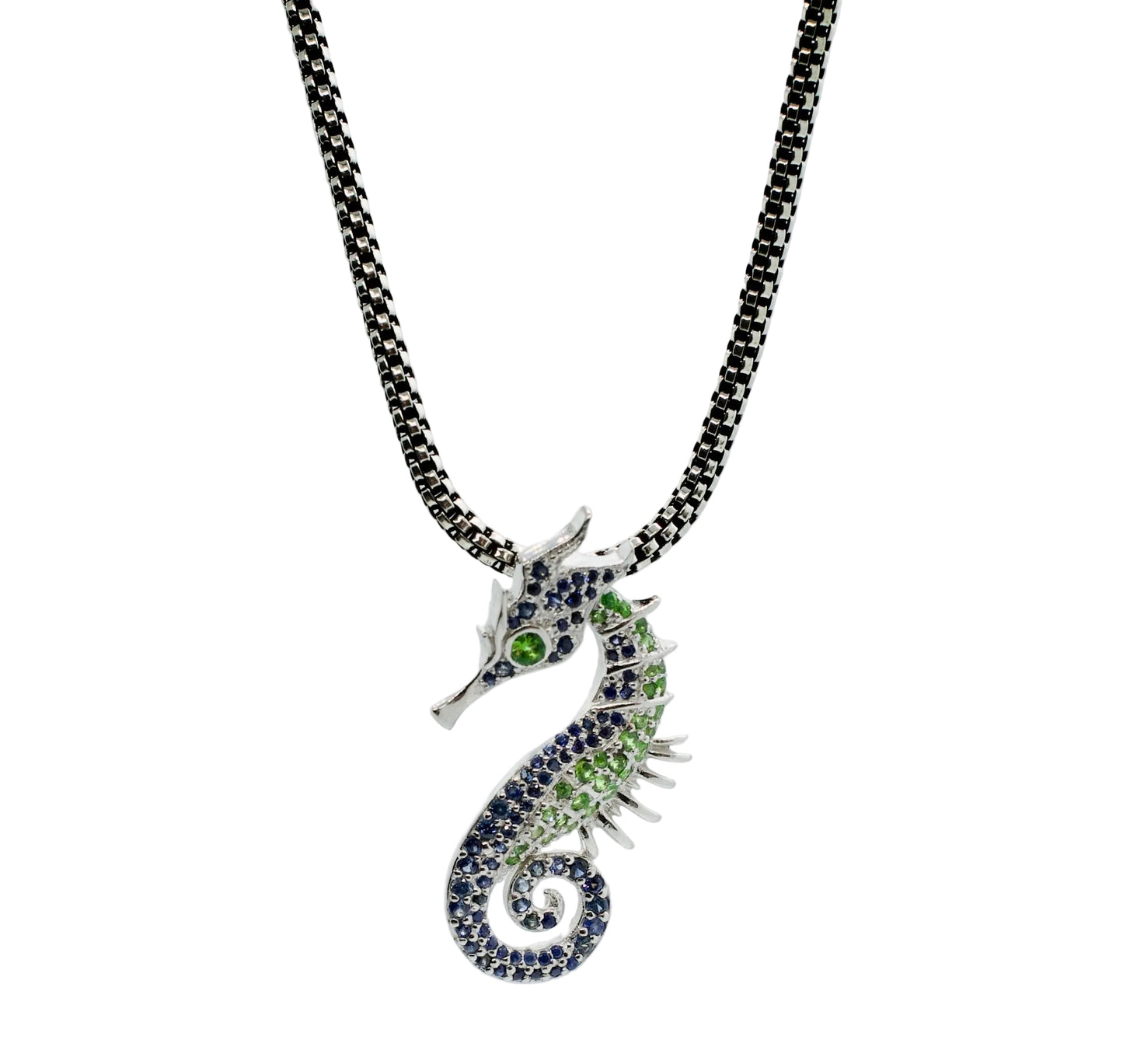 Seahorse pendant necklace with gemstones on a light gray background
