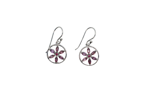 Pair of silver earrings with pink gemstones on a white background