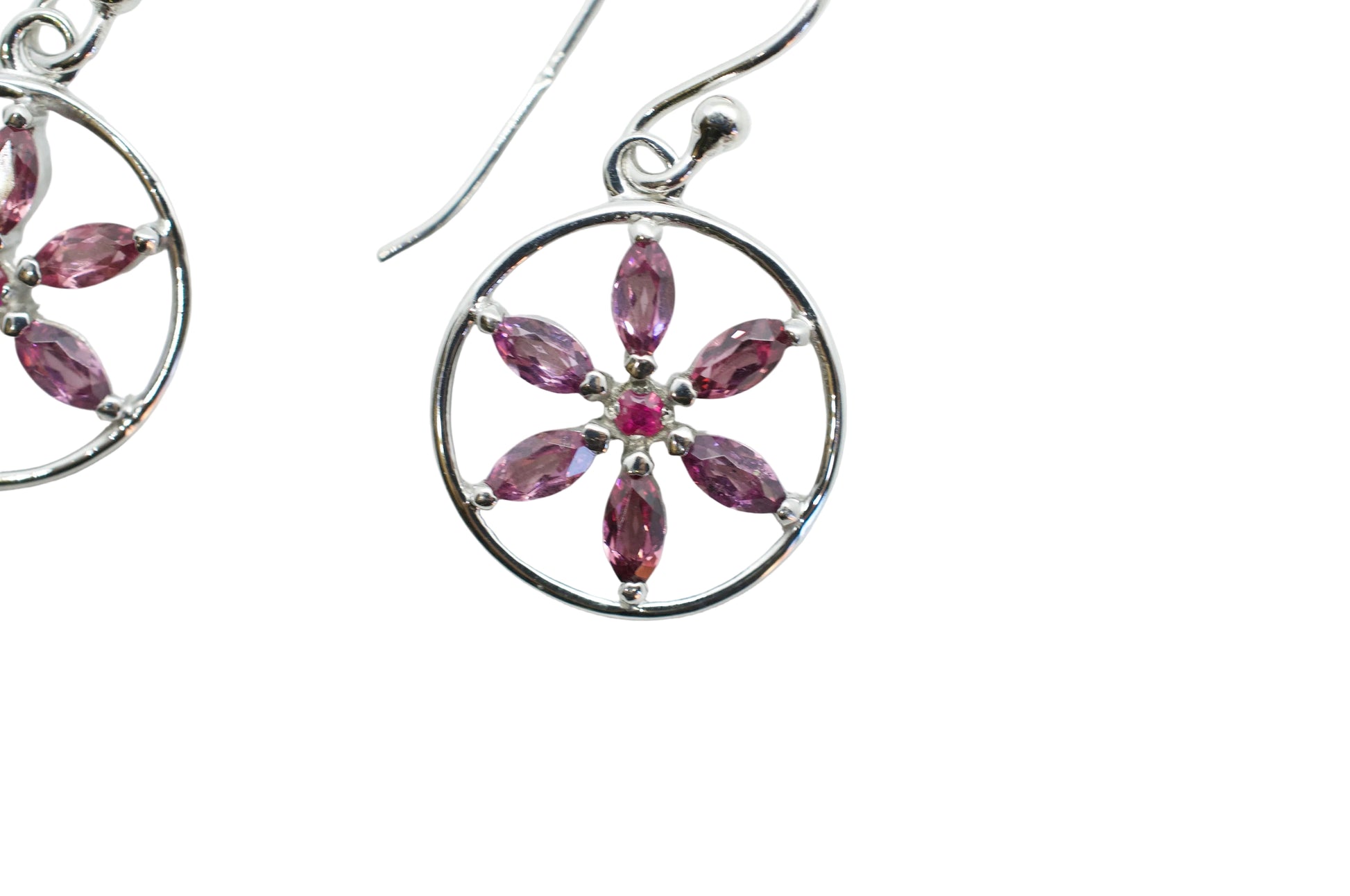 Silver earrings with pink gemstones on a white background