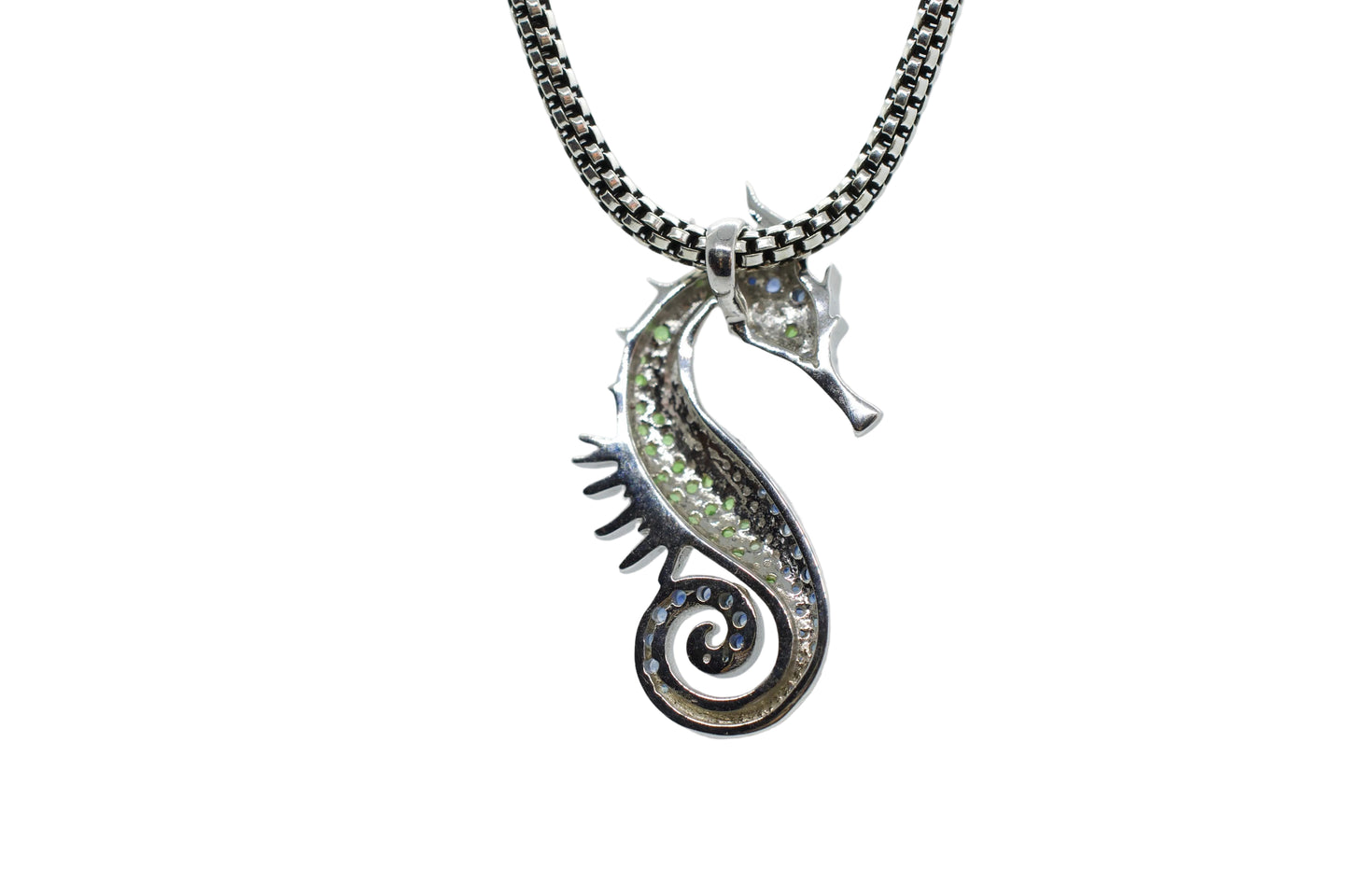 Silver seahorse pendant on a chain against a light gray background