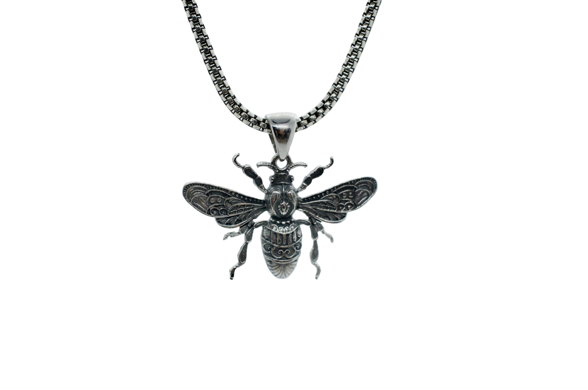 Silver bee pendant on a chain against a light gray background