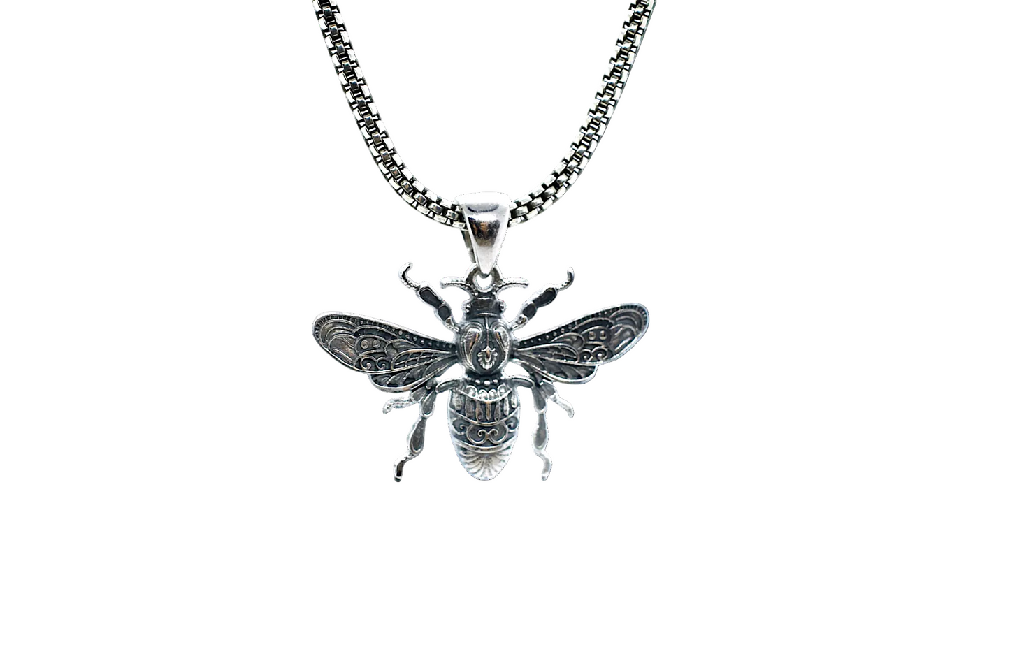Silver bee pendant on a chain against a white background
