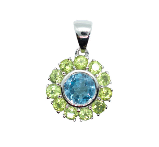 Jewelry pendant with blue gemstone and green stones on a white background