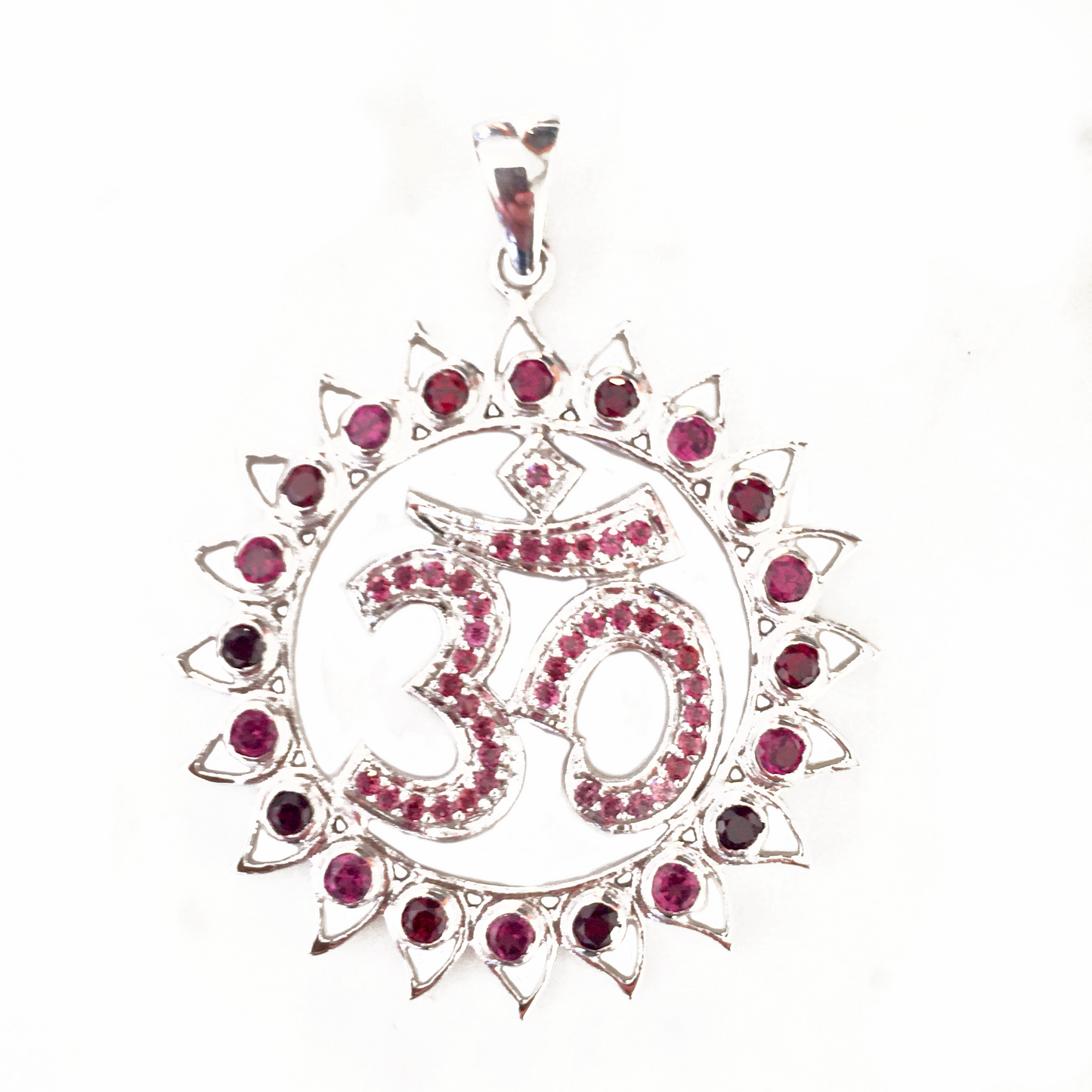 A sterling silver pendant featuring a lotus flower design with a central om symbol, surrounded by garnet and pink tourmaline stones.