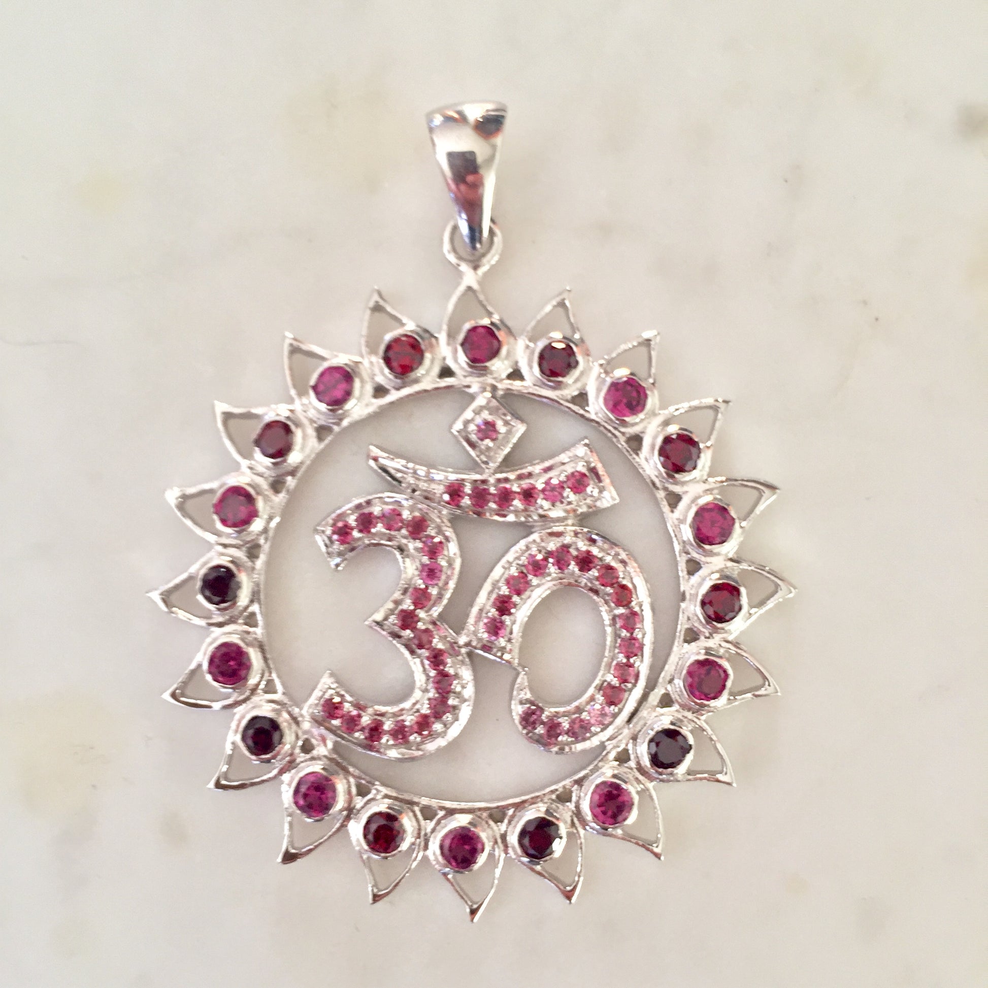 Rhodolite garnet and garnet lotus surrounding a pink tourmaline Om