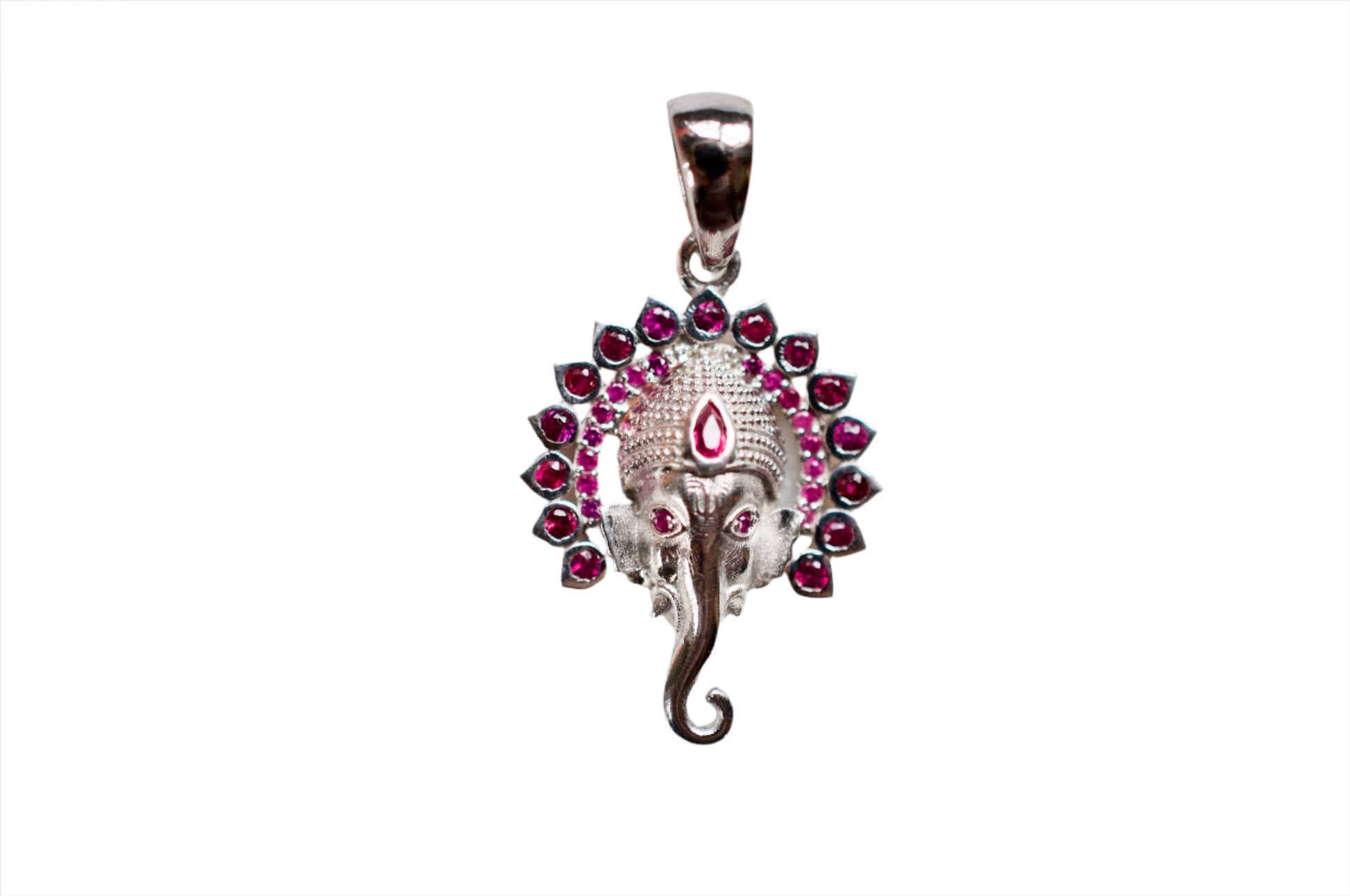 A sterling silver pendant featuring a ruby-encrusted depiction of the Hindu deity Ganesha.